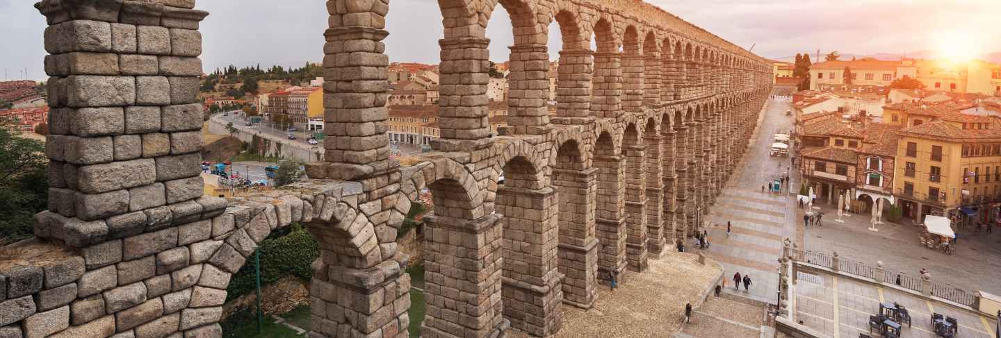 Dramatic sunset in famous segovia aqueduct, castilla y leon, spain